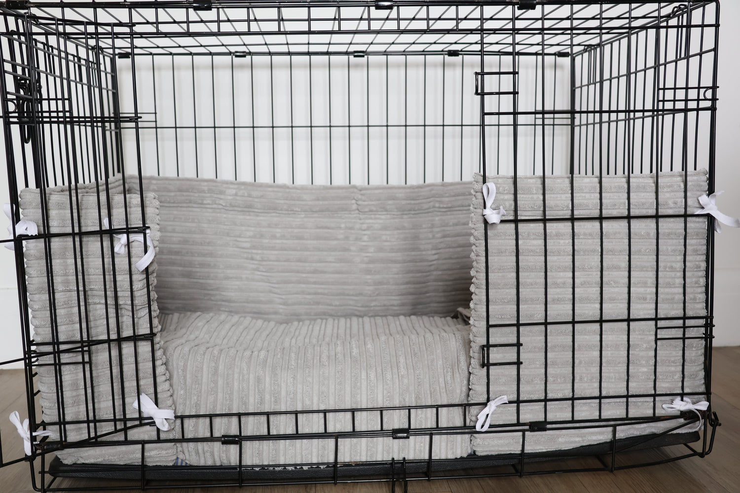 Dog crate bumper pads and matching mattress in grey neutral soft fabric design.