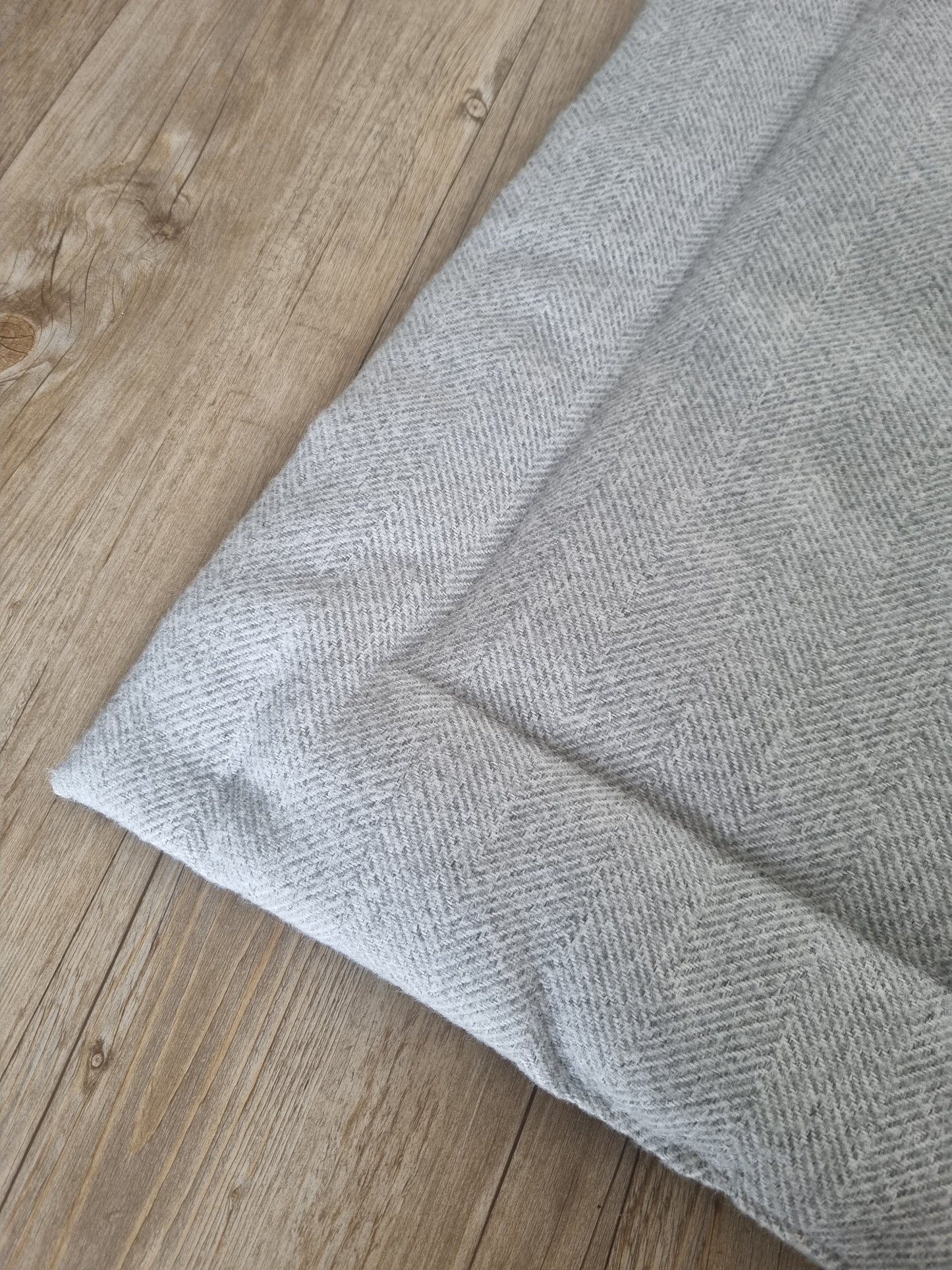 Grey herringbone dog settle mat with roll up fastening to support with puppy settle training.