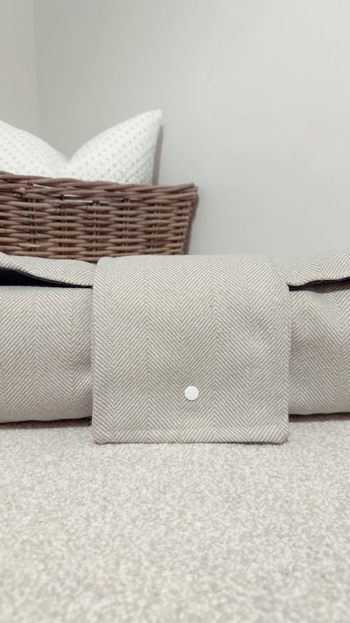 Neutral herringbone dog settle mat with roll up fastening to support with puppy settle training.