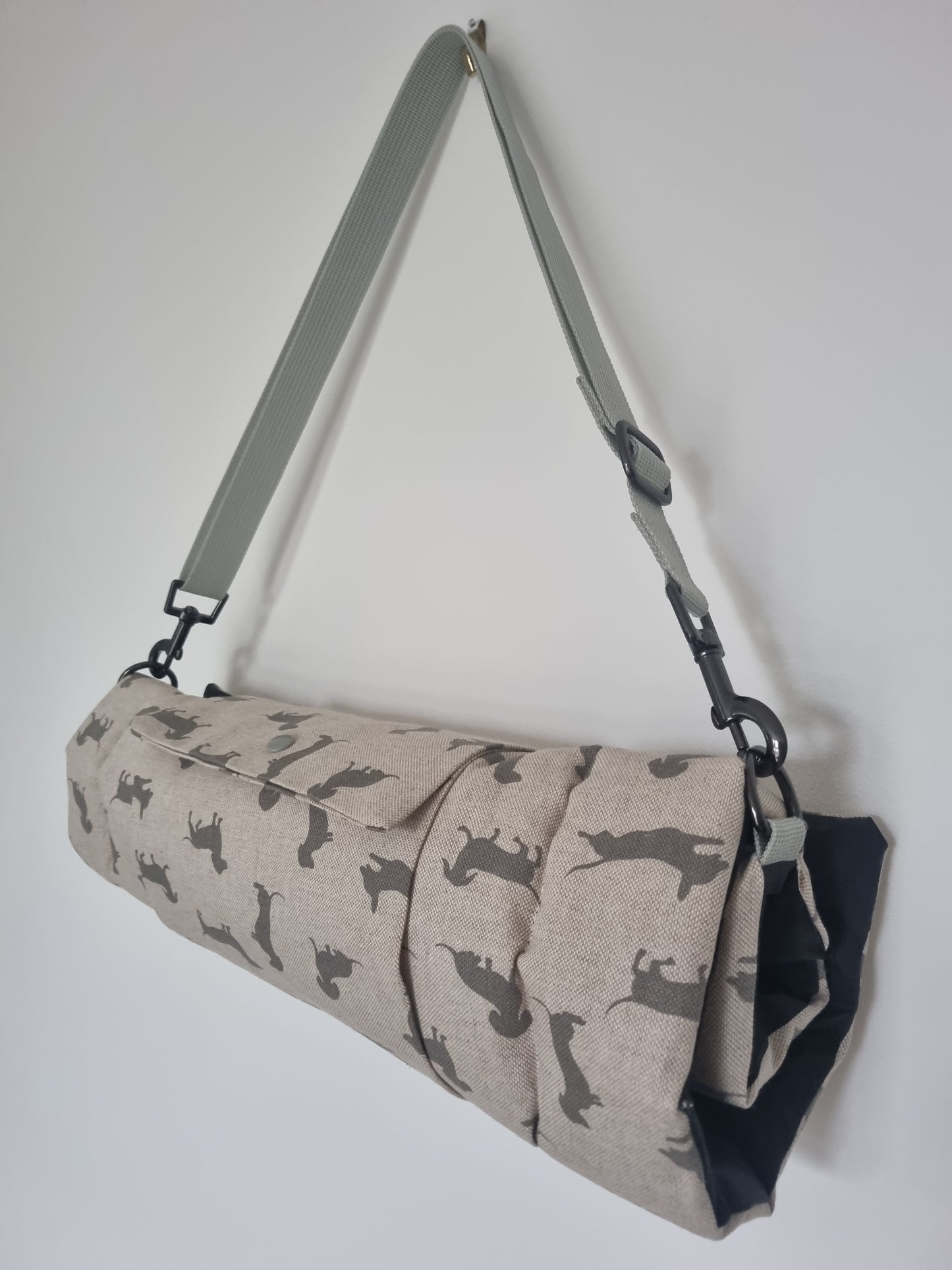 Foldable dog settle mat with roll up fastening and strap to support with puppy settle training.