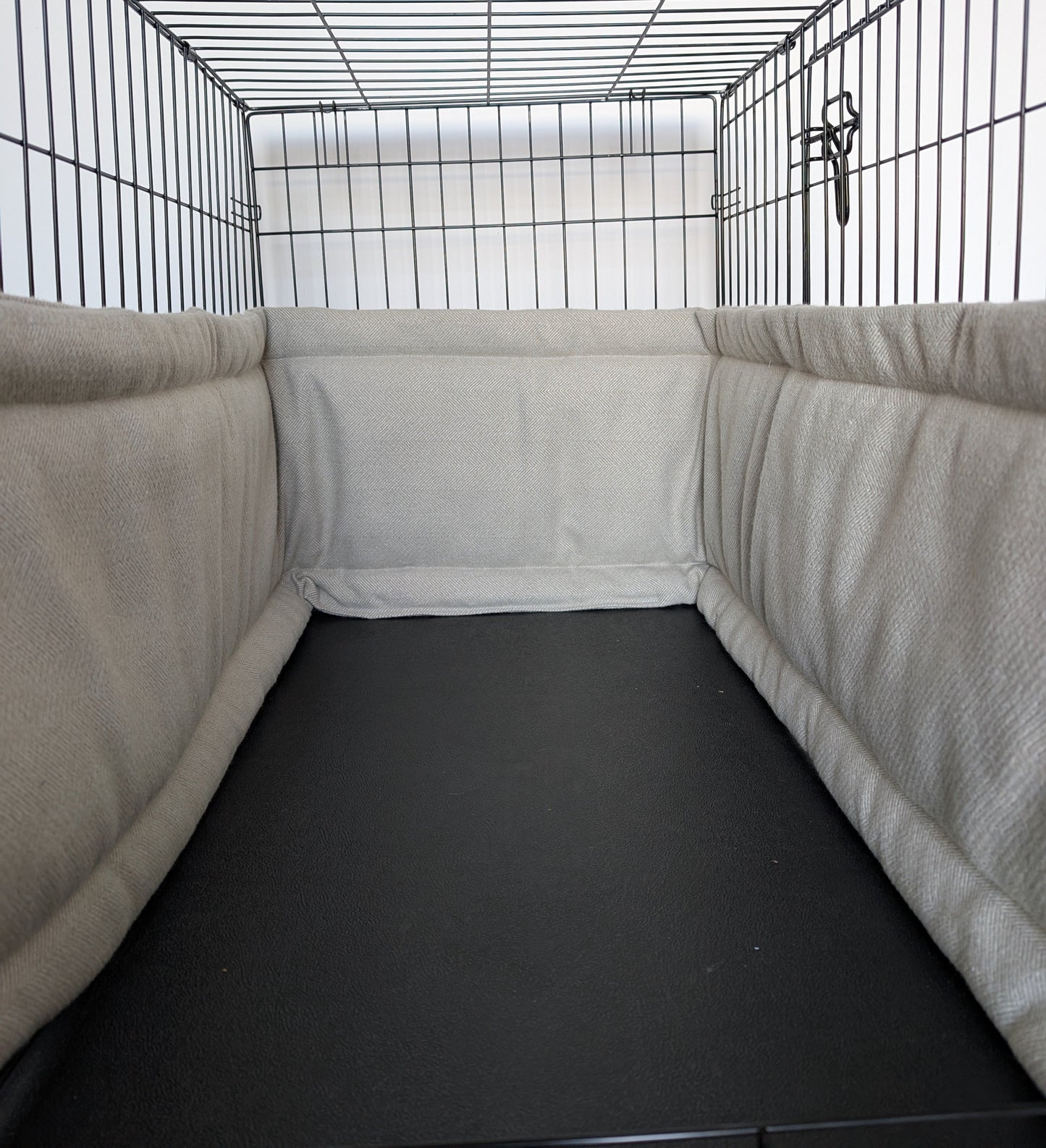 Dog crate bumper and bed - dog crate bedding. Neutral aesthetic herringbone crate bumper pads attaching to metal dog crate to support with puppy training and dog crate training.