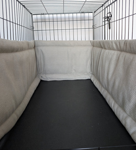 Dog crate bumper and bed - dog crate bedding. Neutral aesthetic herringbone crate bumper pads attaching to metal dog crate to support with puppy training and dog crate training.