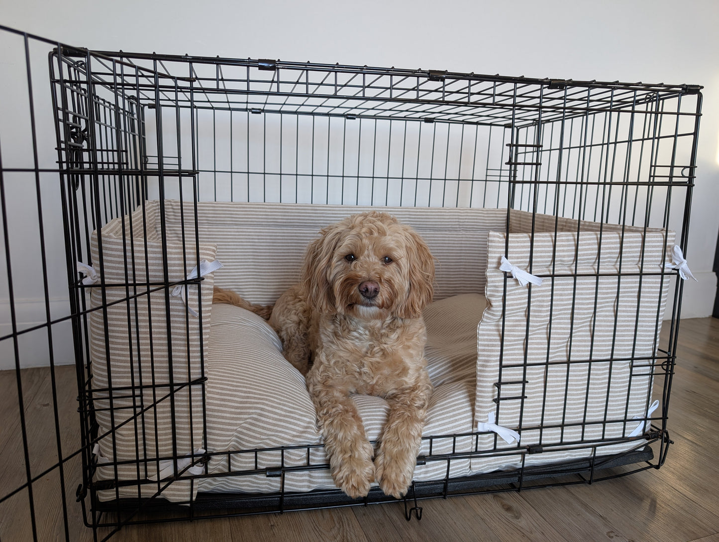 Dog crate bumper and bed. Neutral aesthetic striped dog crate bumper pads with mattress attaching to metal dog crate to support with puppy training and dog training.
