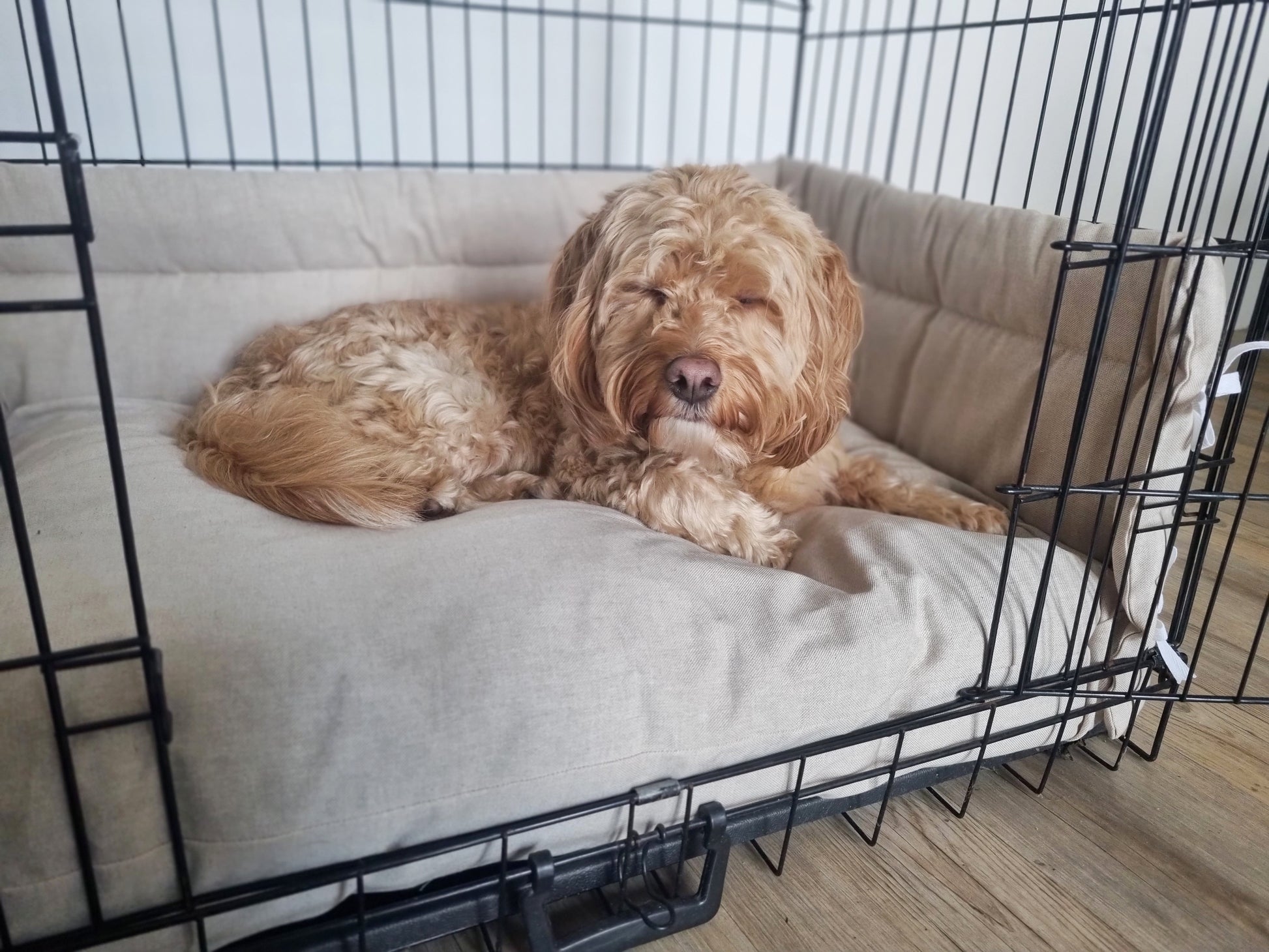 Dog crate bumper and bed - dog crate bedding. Neutral linen-look cotton dog crate bumper pads attaching to metal dog crate to support with puppy training and dog crate training.  Featuring custom dog crate mattress.