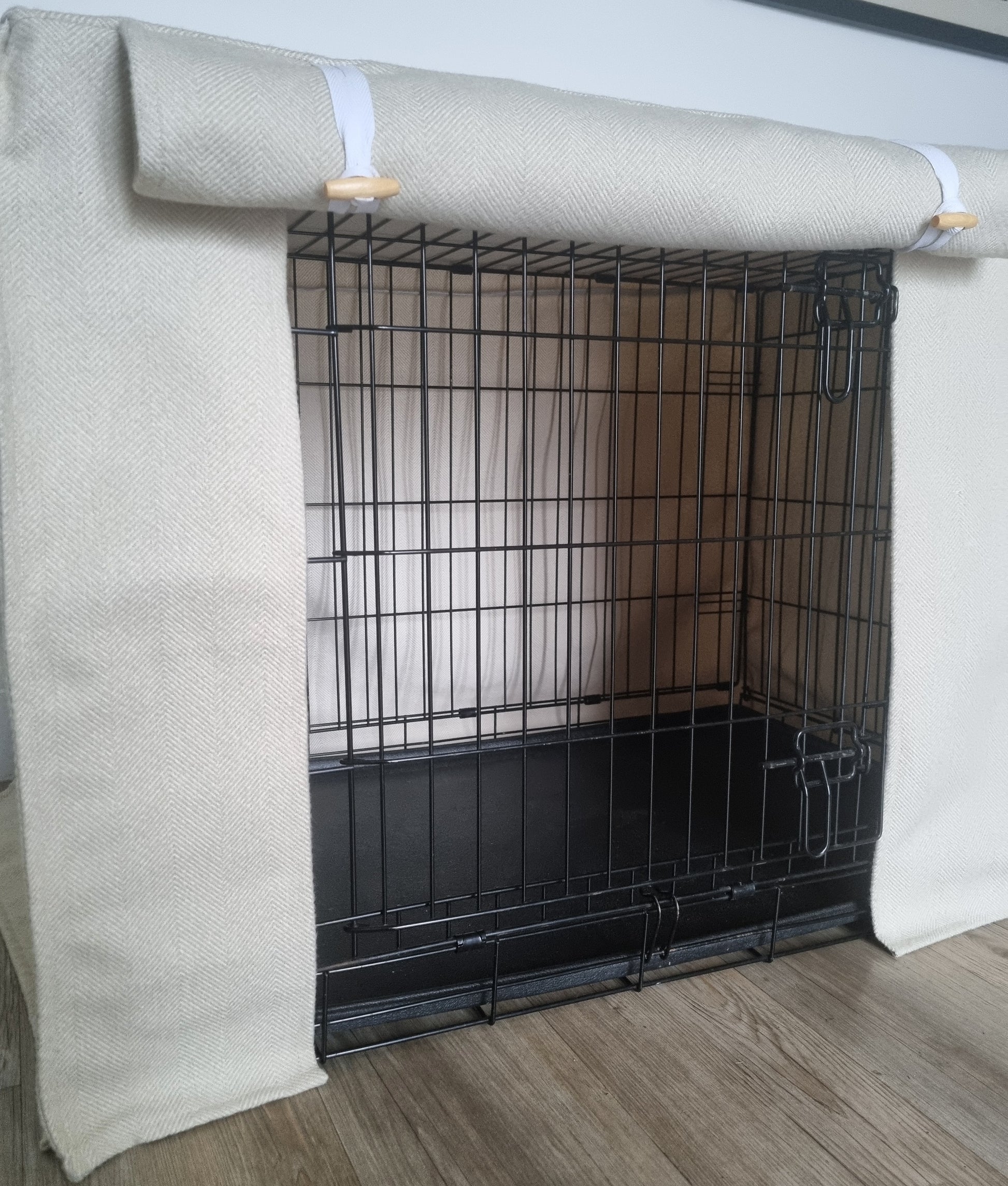 Stylish fabric dog crate cover. The custom kennel cover features a cream-toned, aesthetic design with a herringbone pattern, offering a cosy and decorative touch to the pet's space.