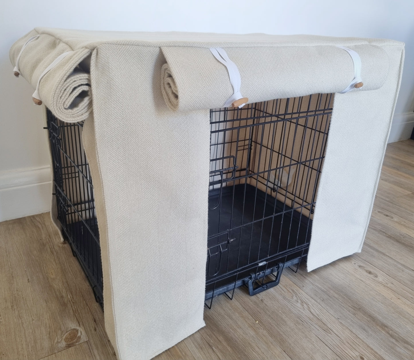 Stylish fabric dog crate cover. The custom kennel cover features a cream-toned, aesthetic design with a herringbone pattern, offering a cosy and decorative touch to the pet's space.