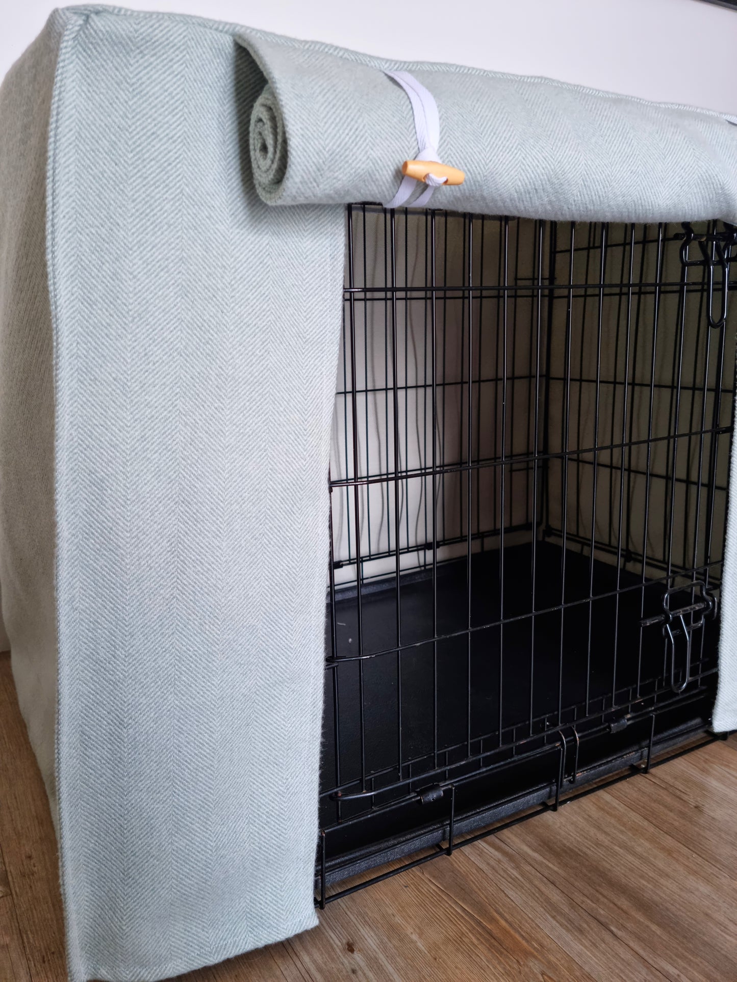 Stylish fabric dog crate cover. The custom kennel cover features a cream-toned, aesthetic design with a herringbone pattern, offering a cosy and decorative touch to the pet's space.