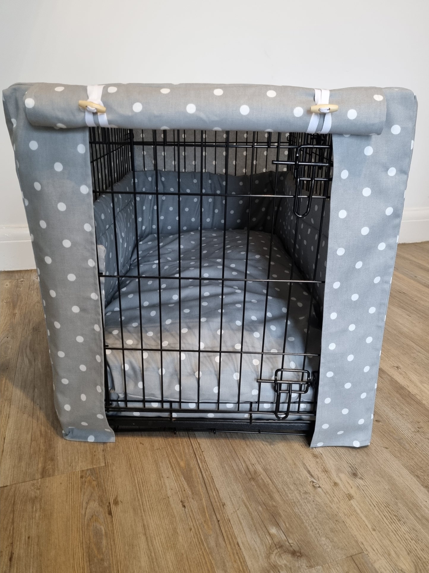 "A black wire dog crate covered with a custom fabric dog crate cover. An aesthetic kennel cover for small, medium, large or xl dogs in a grey spotted cotton fabric. 