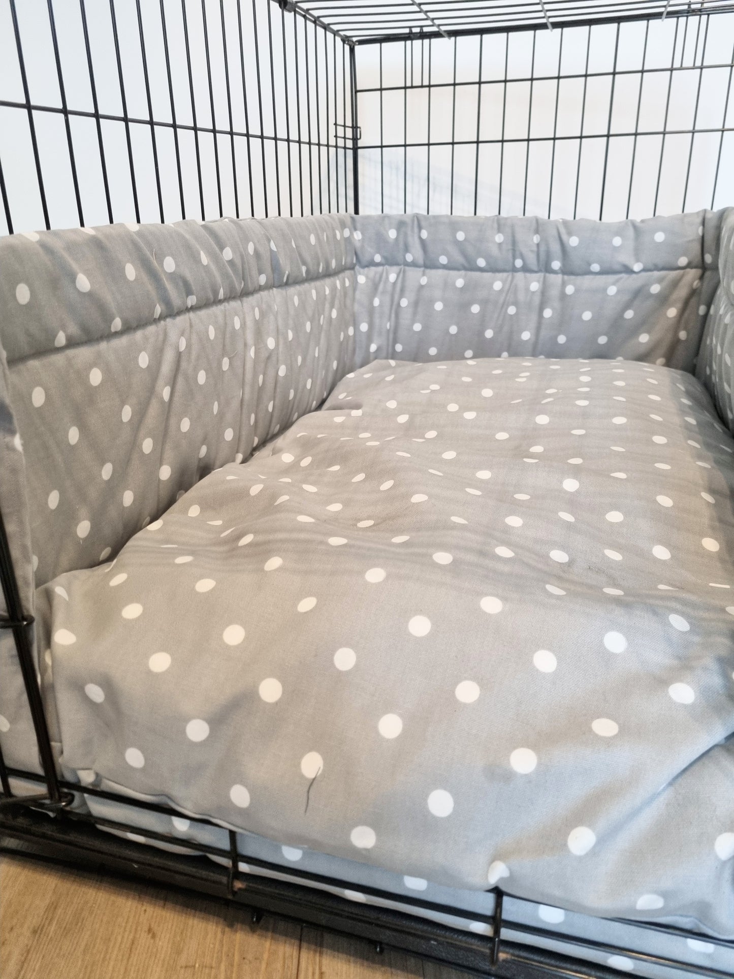 Dog crate bumper and bed - dog crate bedding. Grey spotty cotton dog crate bumper pads attaching to metal dog crate to support with puppy training and dog crate training.  Featuring custom dog crate mattress.