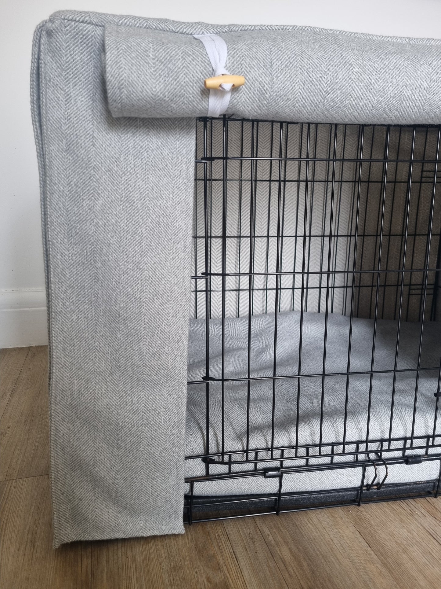 Stylish fabric dog crate cover. The custom kennel cover features a grey-toned, aesthetic design with a herringbone pattern, offering a cosy and decorative touch to the pet's space.