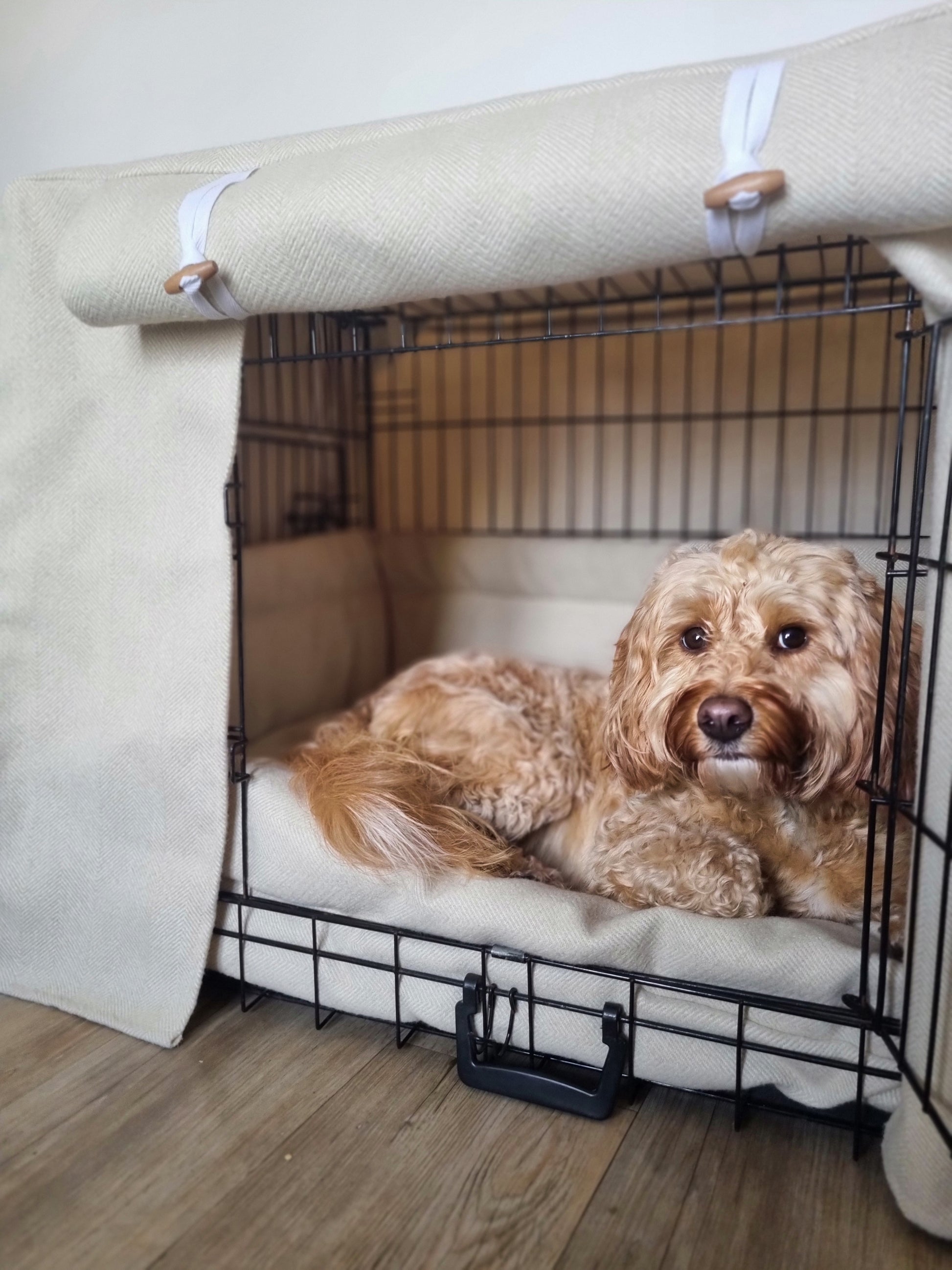 Stylish fabric dog crate cover. The custom kennel cover features a cream-toned, aesthetic design with a herringbone pattern, offering a cosy and decorative touch to the pet's space.