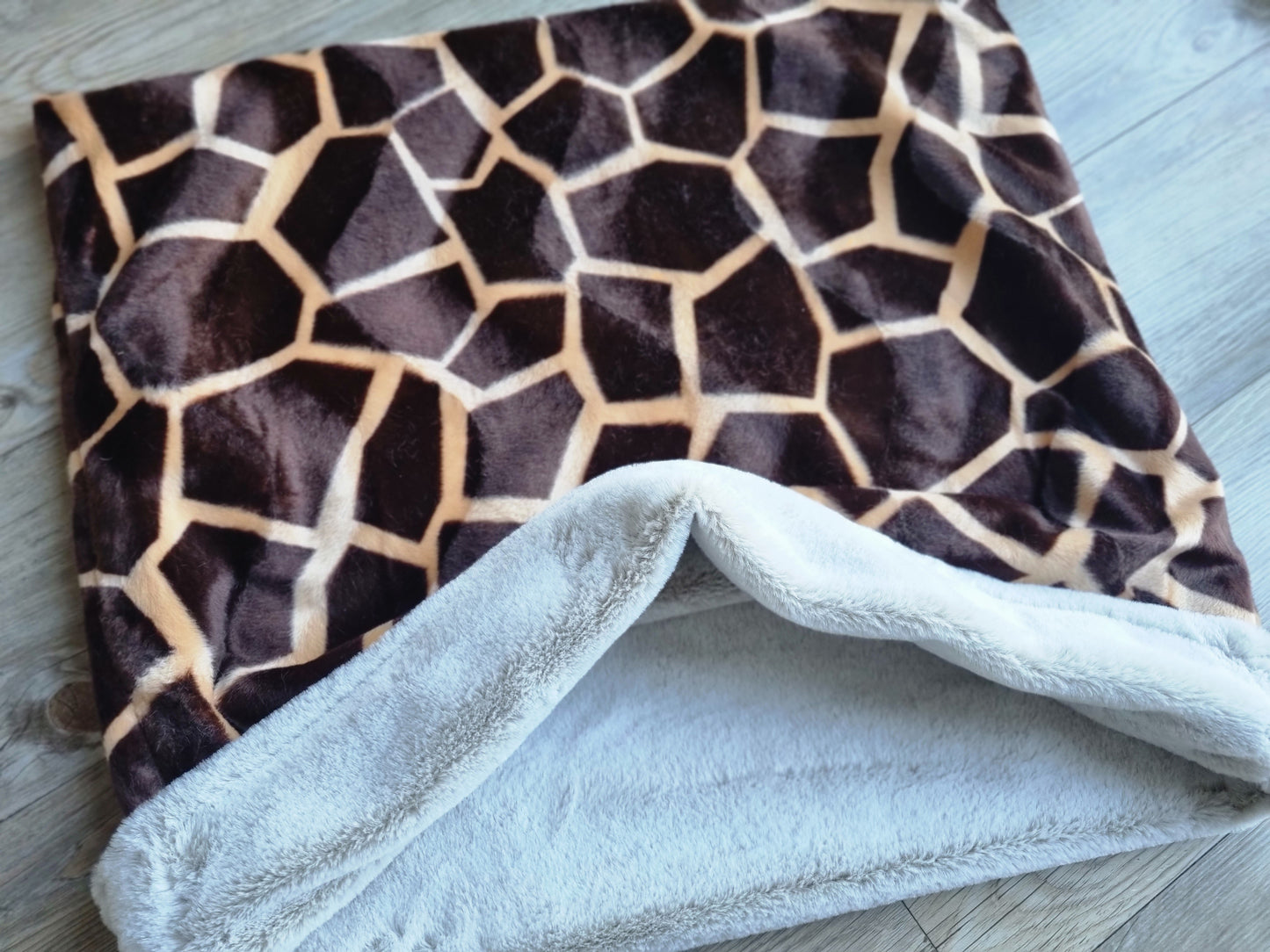 Giraffe print snuggle sack for dogs. This animal print snuggle den provides comfort and warmth to all dogs, cats, guinea pigs.