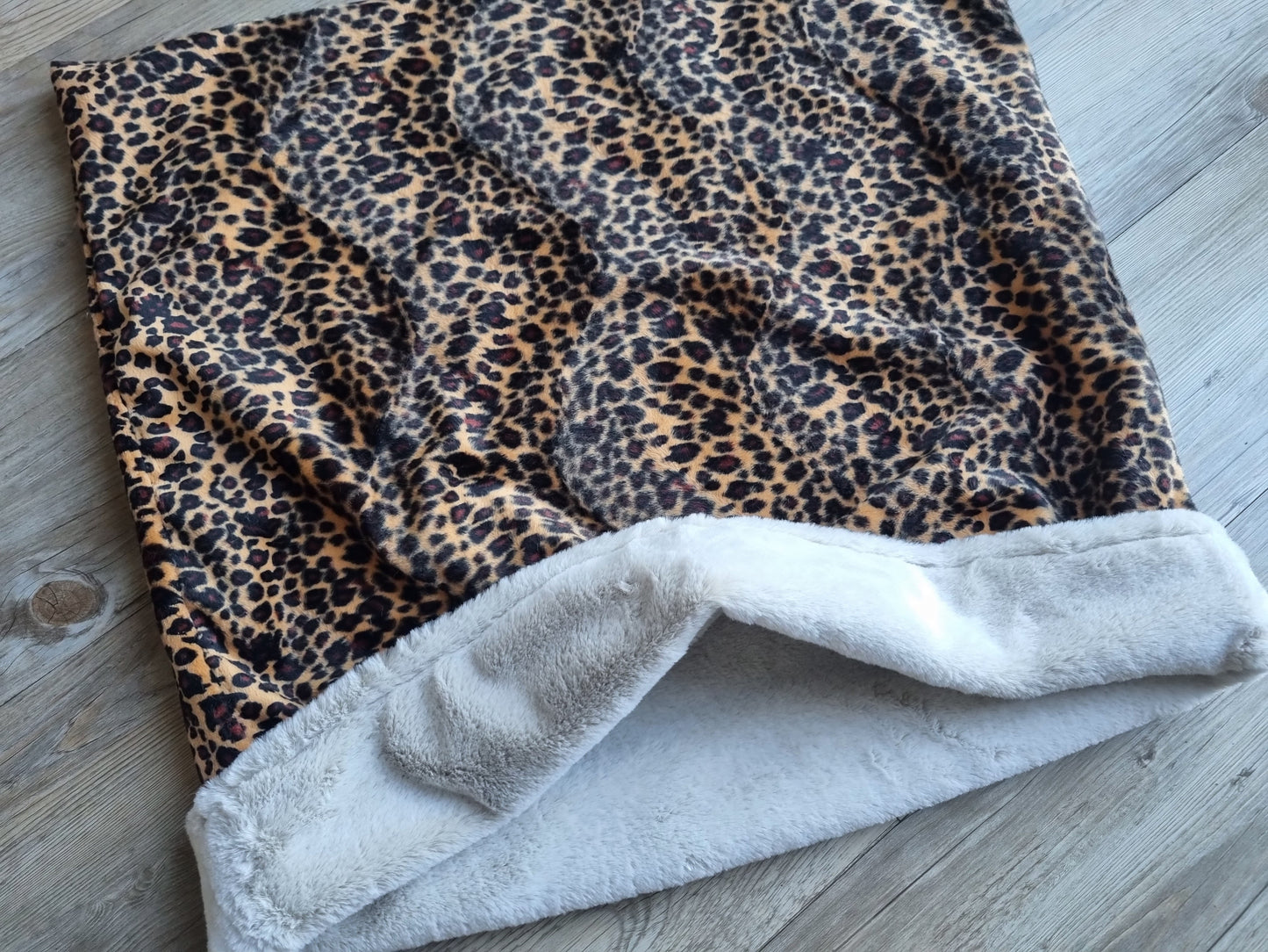 Leopard print snuggle sack for dogs. This animal print snuggle den provides comfort and warmth to all dogs, cats, guinea pigs.