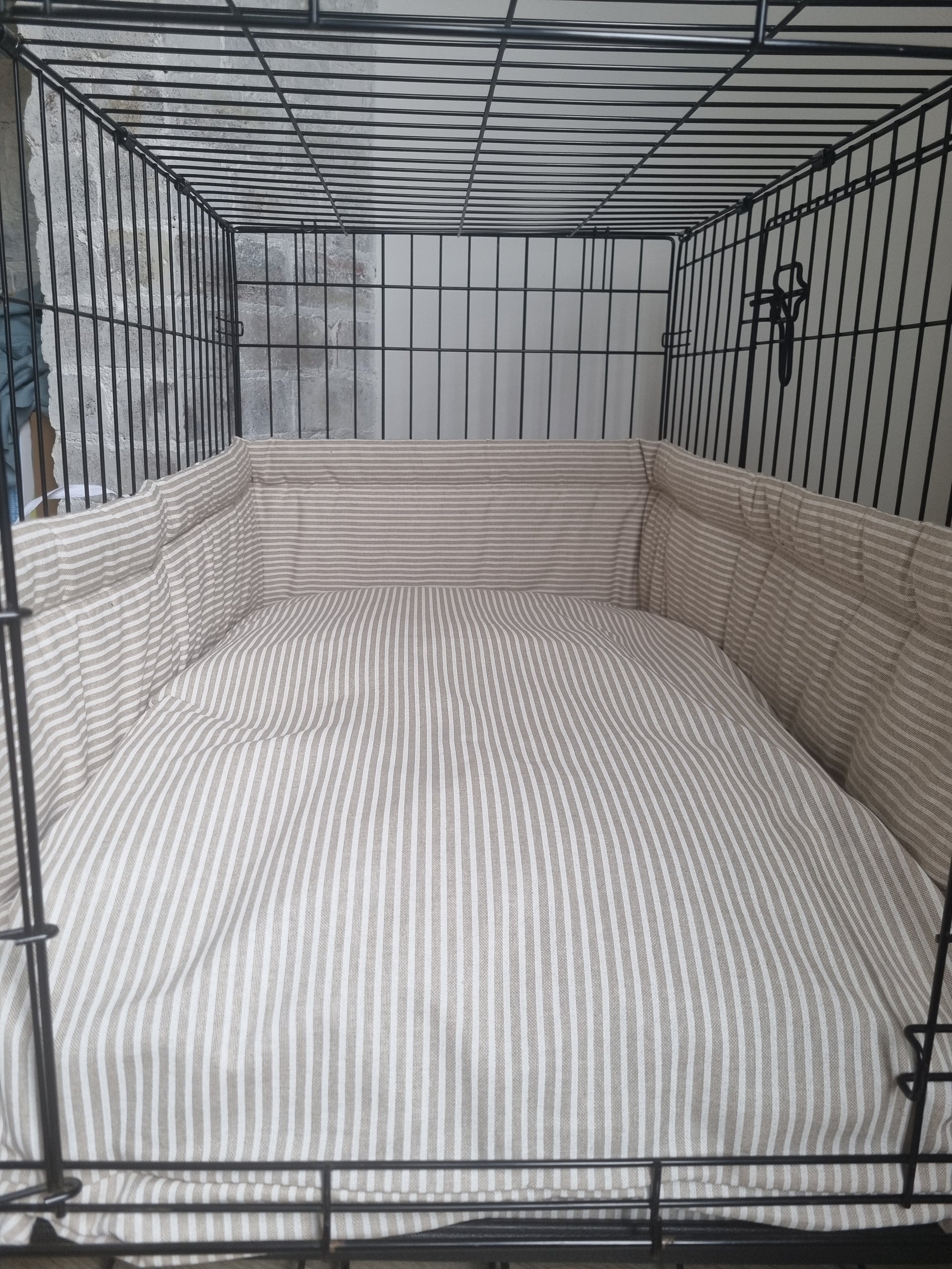 Dog crate bumper and bed - dog crate bedding. Neutral beige and white ticking striped dog crate bumper pads attaching to metal dog crate to support with puppy training and dog crate training. 