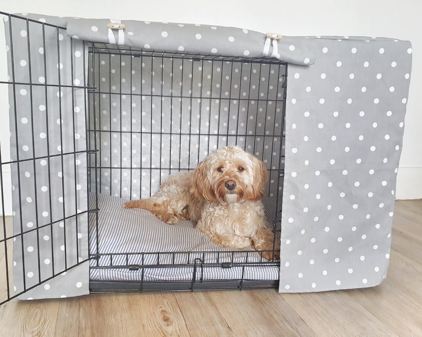 "A black wire dog crate covered with a custom fabric dog crate cover. An aesthetic kennel cover for small, medium, large or xl dogs in a grey spotted cotton fabric. 