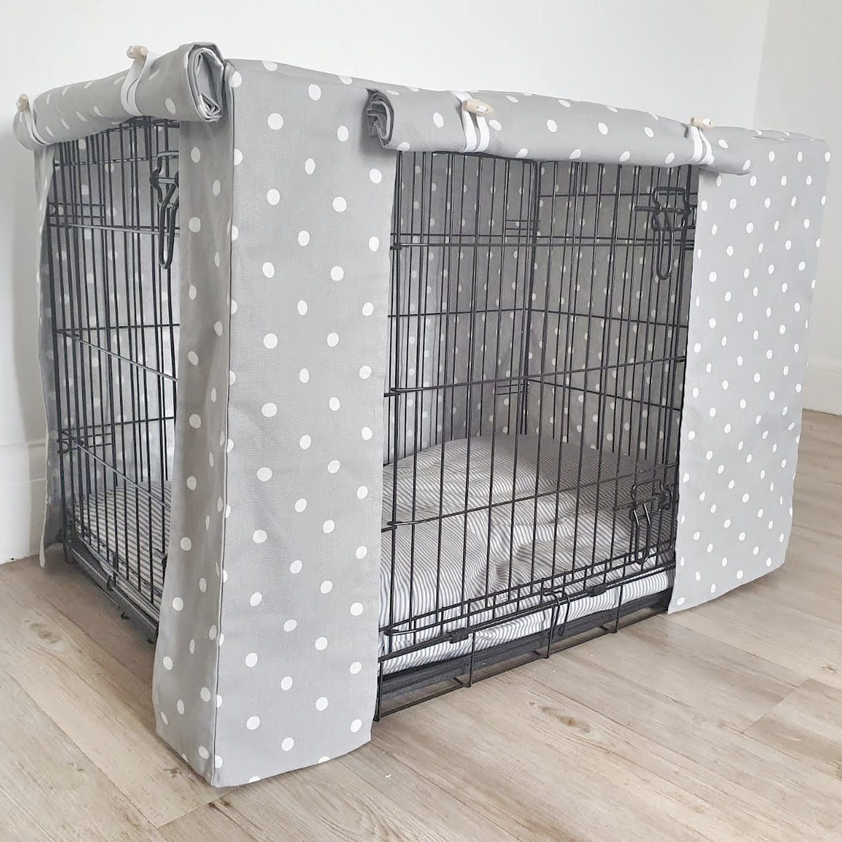 "A black wire dog crate covered with a custom fabric dog crate cover. An aesthetic kennel cover for small, medium, large or xl dogs in a grey spotted cotton fabric. 