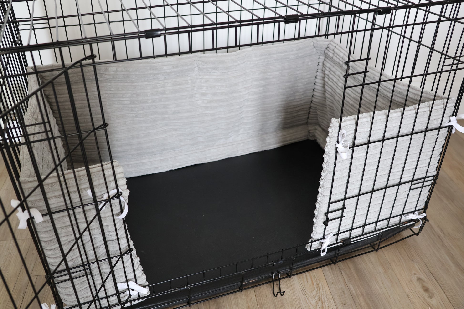 Dog crate bumper. Soft grey dog crate bumper pads attaching to metal dog crate to support with puppy training and dog training. 