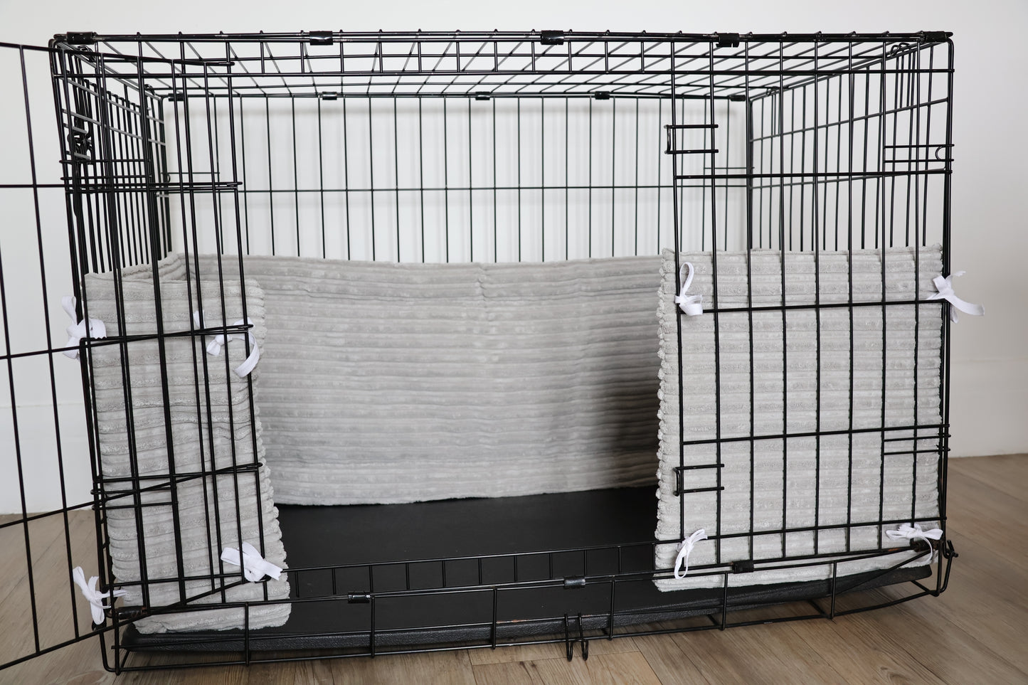 Dog crate bumper. Soft grey dog crate bumper pads attaching to metal dog crate to support with puppy training and dog training. 