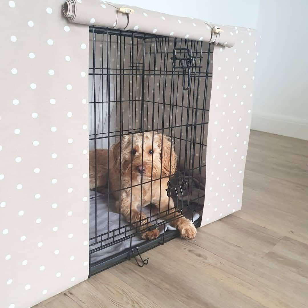 "A black wire dog crate covered with a custom fabric dog crate cover in a taupe spotty design. The aesthetic kennel cover features a minimalist design with a roll-up front panel.