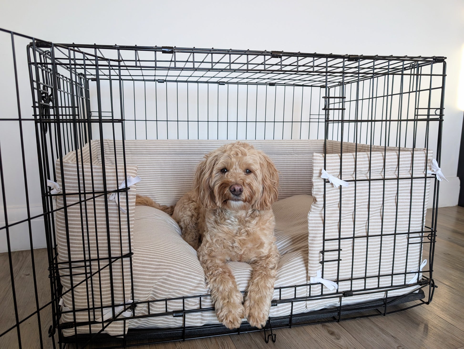 Dog crate bumper and bed - dog crate bedding. Neutral beige and white ticking striped dog crate bumper pads attaching to metal dog crate to support with puppy training and dog crate training. 